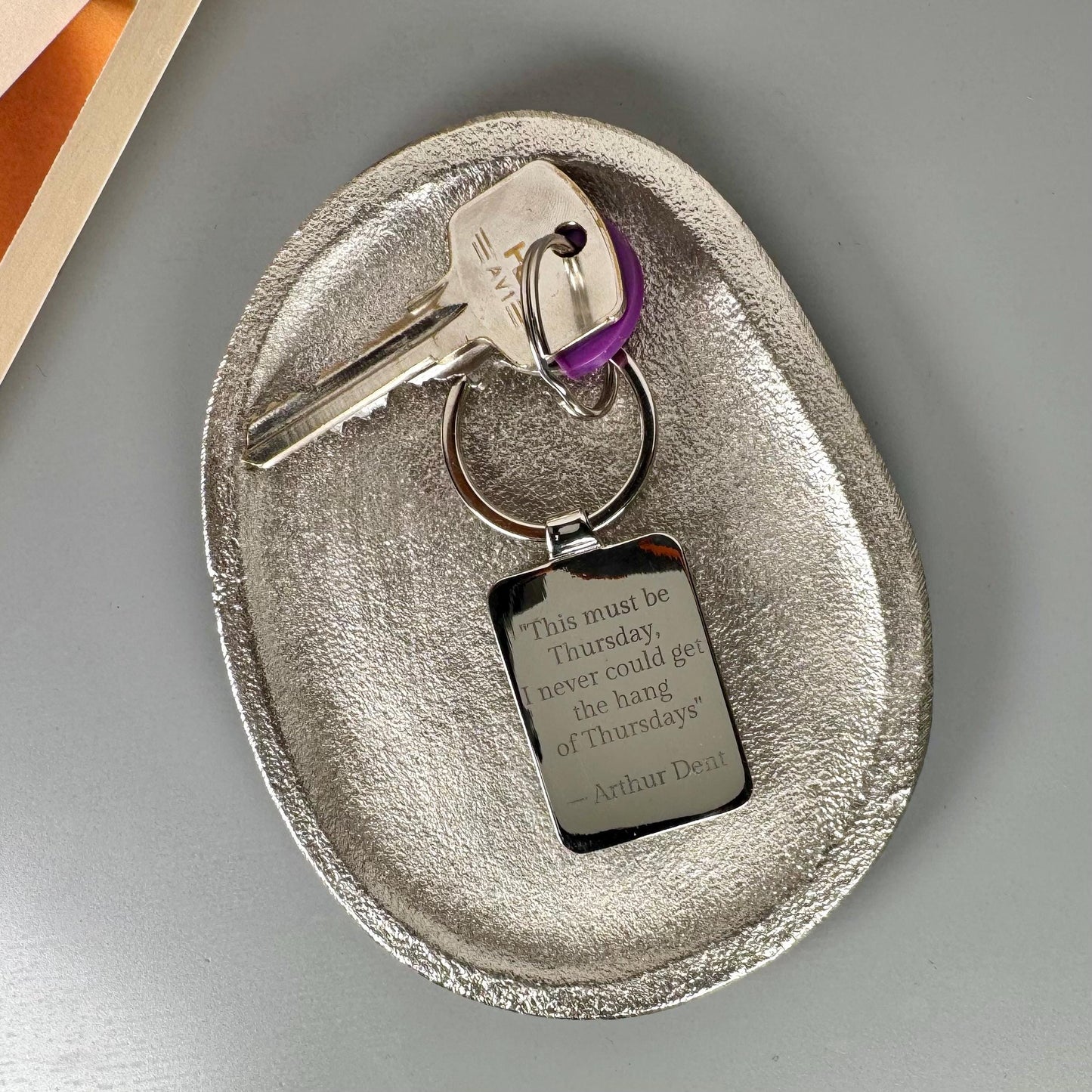 Personalised book cover keyring with engraved message