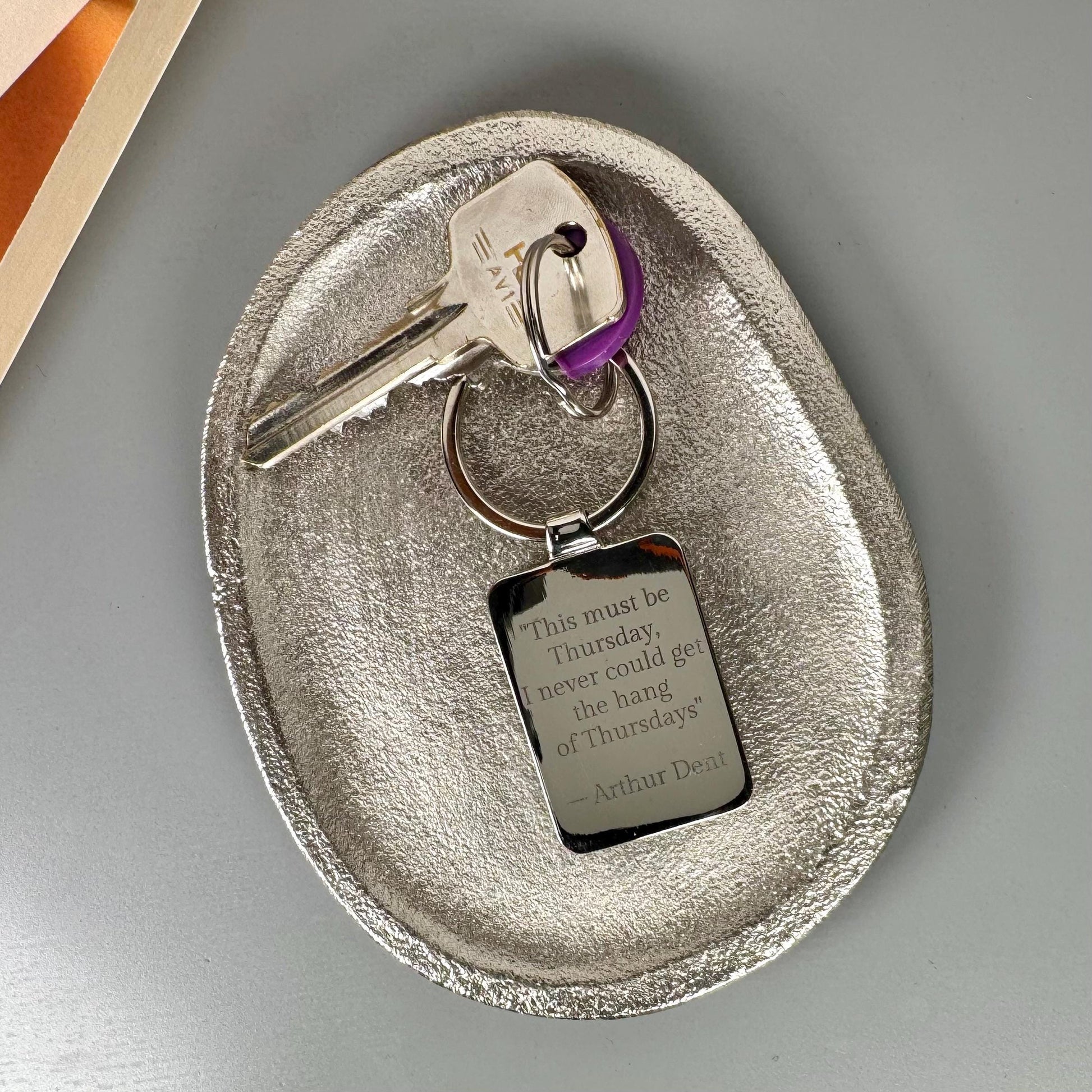 Personalised book cover keyring with engraved message